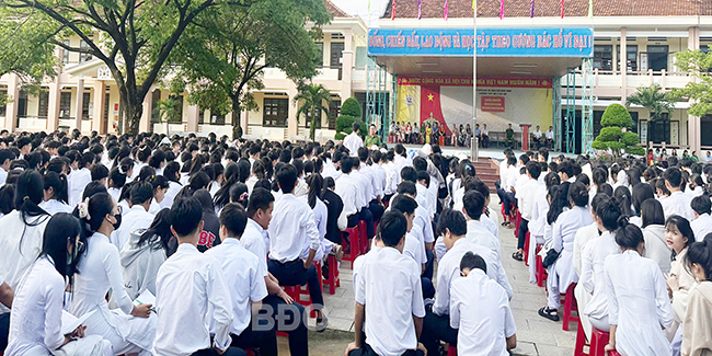 Ông Huỳnh Ngọc Biên (đứng giữa) trao trả tiền nhặt được cho anh Sang. Ảnh: V.T